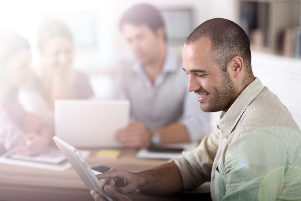 Young man in office working on digital tablet